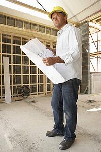 Architect With Plans In New Home