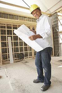 Architect With Plans In New Home