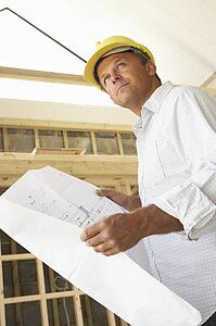 Architect With Plans In New Home