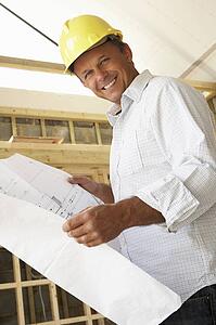 Architect With Plans In New Home