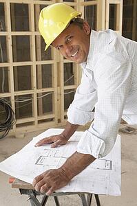 Architect Studying Plans In New Home
