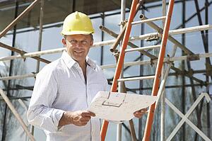 Architect Studying Plans Outside New Home