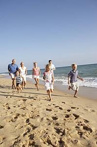 Portrait Of Three Generation Family On Beach Holiday