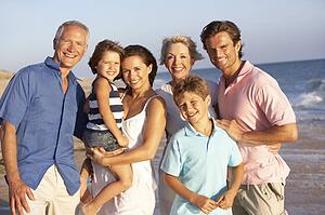 Portrait Of Three Generation Family On Beach Holiday