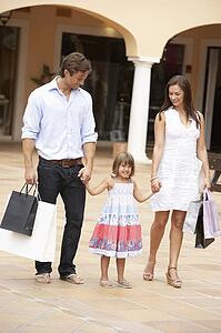 Young Family Enjoying Shopping Trip Together