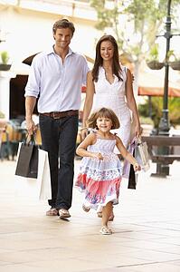 Young Family Enjoying Shopping Trip Together