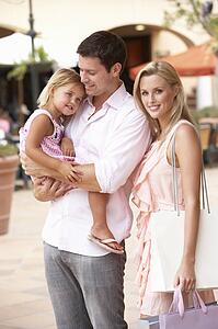 Young Family Enjoying Shopping Trip Together