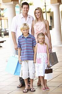 Young Family Enjoying Shopping Trip Together