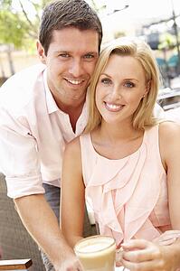 Young Couple Enjoying Coffee In Café
