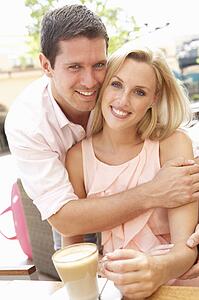 Young Couple Enjoying Coffee In Café