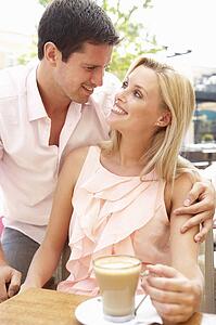Young Couple Enjoying Coffee In Café