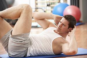 Man Doing Stretching Exercises In Gym