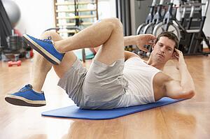 Man Doing Stretching Exercises In Gym