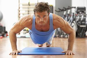 Man Doing Press Ups In Gym
