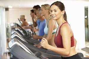 Woman On Running Machine In Gym