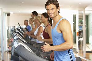 Man On Running Machine In Gym