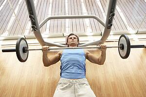 Man Working With Weights In Gym
