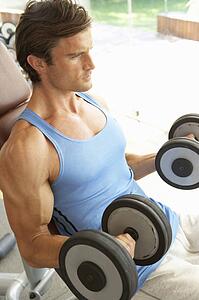 Man Working With Weights In Gym