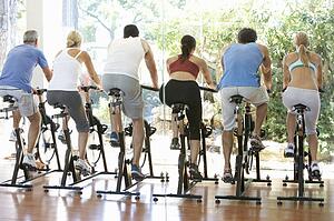 Group Of People In Spinning Class In Gym
