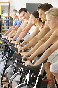 Man Cycling In Spinning Class In Gym