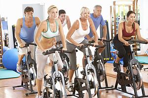 Group Of People In Spinning Class In Gym