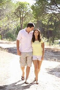 Young couple, holding hands, walking, walk in park