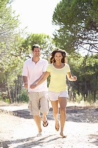 Young couple, holding hands, walking, walk in park