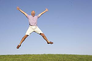 Senior man jumping in air