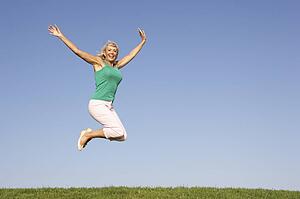 Senior woman jumping in air