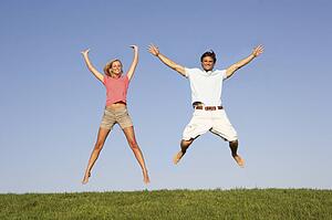 Young couple jumping in air