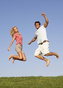 Young couple jumping in air