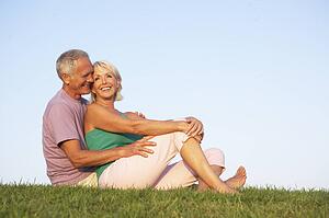 Senior couple posing on a field