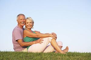 Senior couple posing on a field