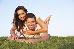 Young couple posing on a field