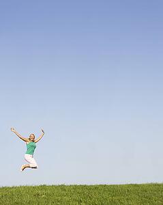 Senior woman jumping in air
