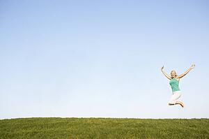Senior woman jumping in air