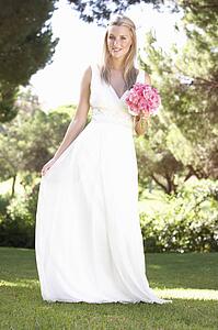 Bride Wearing Dress Holding Bouqet At Wedding
