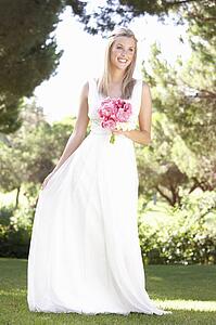 Bride Wearing Dress Holding Bouqet At Wedding
