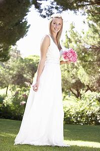Bride Wearing Dress Holding Bouqet At Wedding
