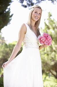 Bride Wearing Dress Holding Bouqet At Wedding