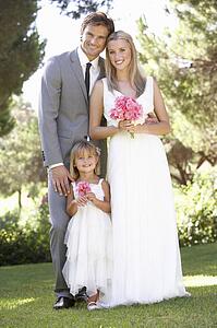 Bride And Groom With Bridesmaid At Wedding