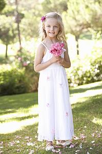 Portrait Of Bridesmaid Holding Bouquet Outdoors