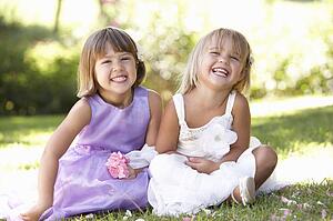 Two young girls posing in park