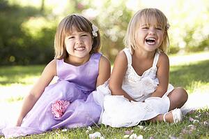 Two young girls posing in park