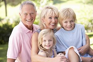 Senior couple with children posing in park