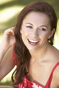 Portrait Of Young Woman Relaxing In Park