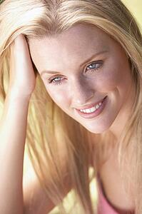 Portrait Of Young Woman Relaxing In Park
