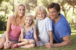Young parents with children posing in a park