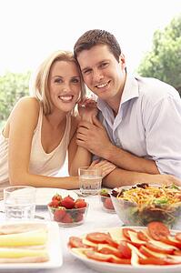 Young couple eating outdoors