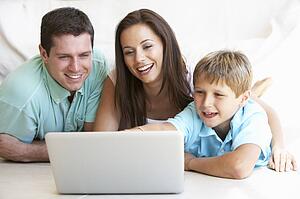 Young parents, with child, on laptop computer